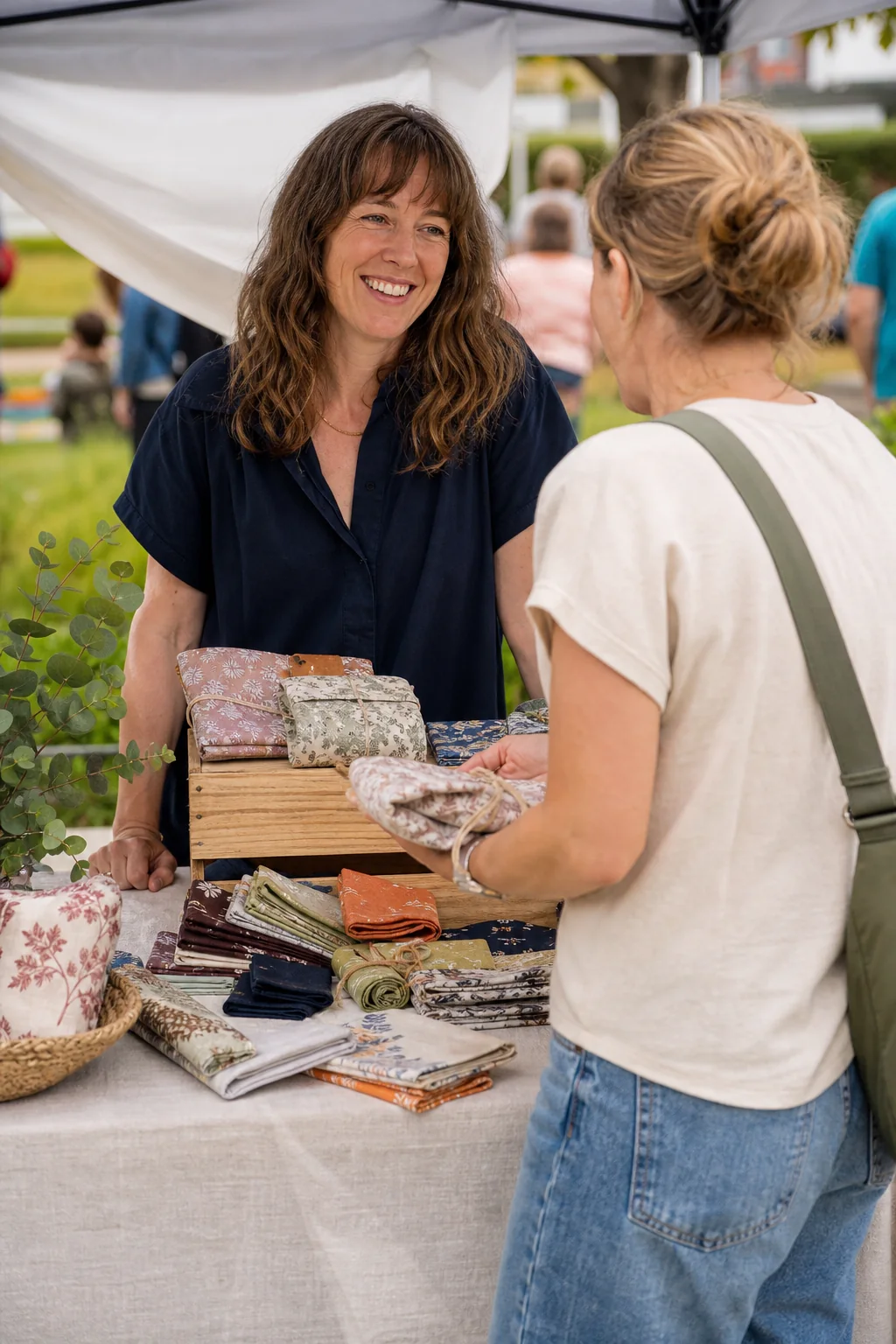 AI-generated illustrative concept art showing a maker speaking with a visitor at a craft-fair stall.