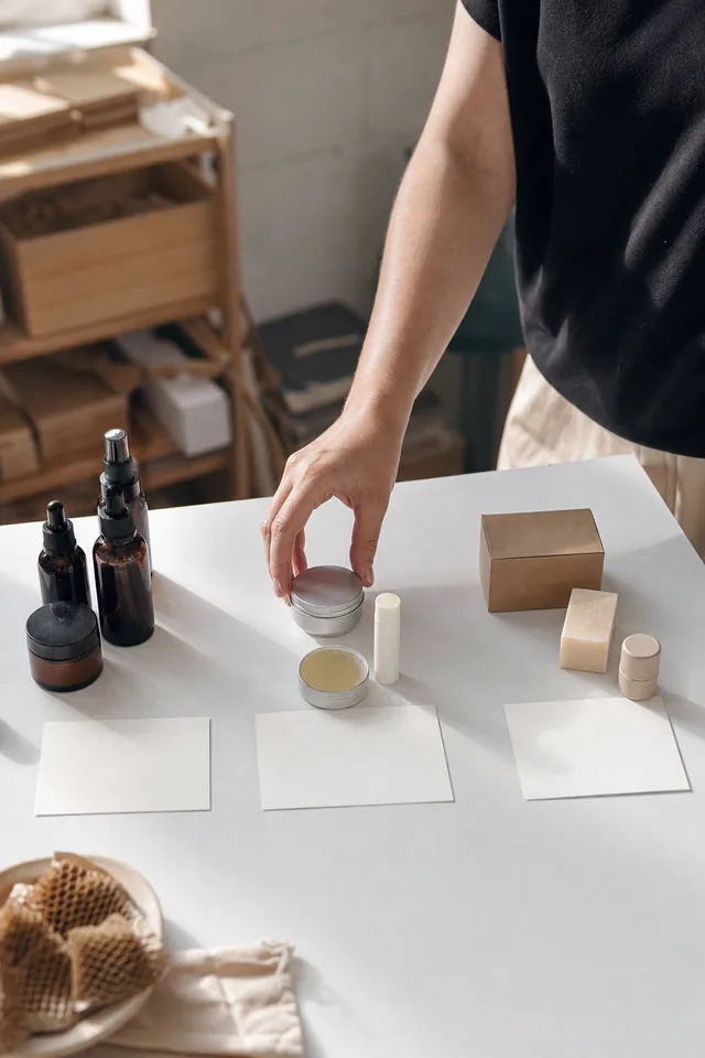 Hands organise small products and parcels for a launch plan.